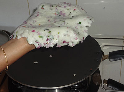putting akki rotti on the pan