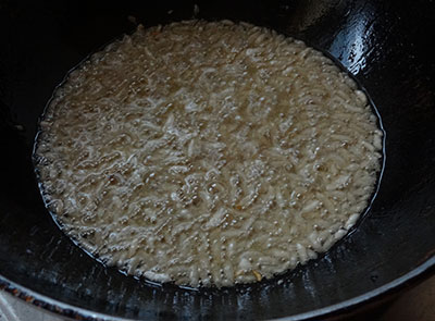 deep frying thick beaten rice for avarekalu mixture