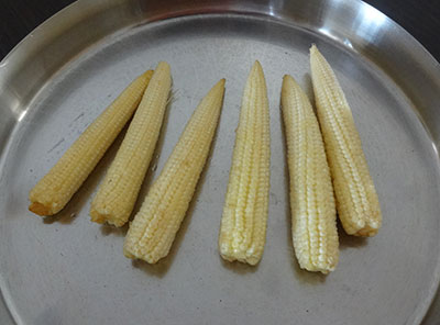 peeling baby corns for baby corn golden fry