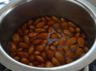 almonds in boiling water for badam burfi or badam katli