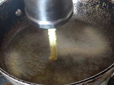 pressing benne murukku or butter chakli