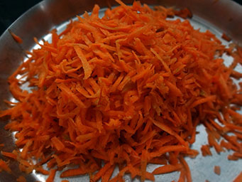 peeling and grating carrot for carrot halwa