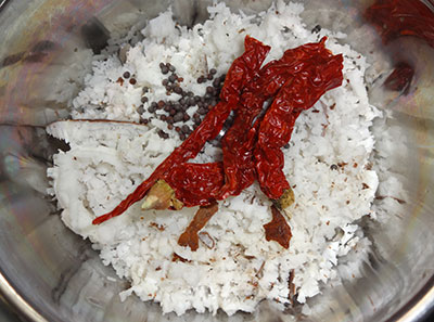 grind coconut and red chili for hagalakayi palya or bitter gourd stir fry