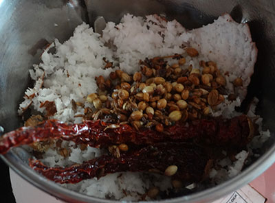 grinding coconut and spices for halasina beejada saaru or jackfruit seeds rasam