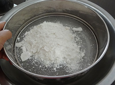 sieving the rice flour for athrasa or kajjaya