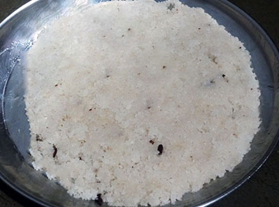 levelling the kayi burfi or coconut burfi mixture