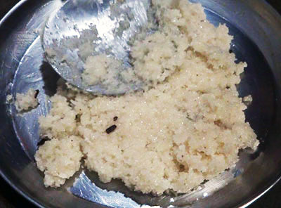 transfer kayi burfi or coconut burfi mixture to greased plate