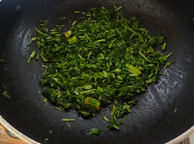 fry coriander leaves and green chili for kothambari soppu thambli or coriander leaves tambli
