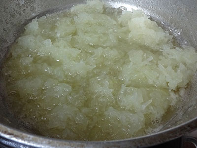 stirring grated ashgourd for kumbalakayi or kashi or dumroot halwa