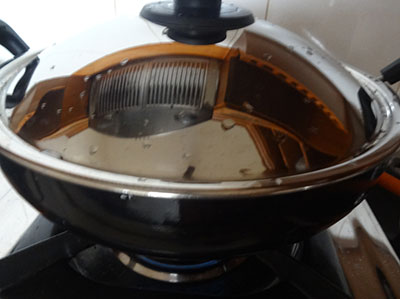 frying and cooking bitter gourd for pineapple curry or ananas gojju