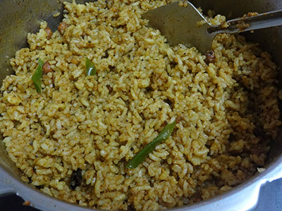 mixing Iyengar style puliyogare or tamarind rice