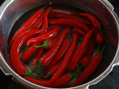 rinsing chilies for ranjaka or red chili chutney