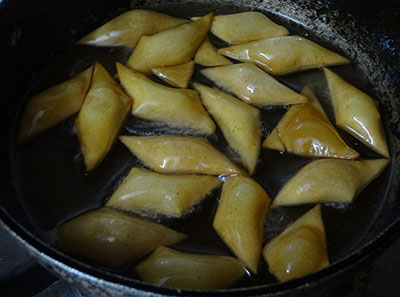 deep frying spicy shankar poli or shankar pali