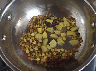 crushing pepper and cumin for shunti saaru or ginger rasam