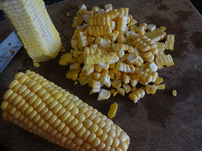 scraping sweet corn for  buttered sweet corn recipe