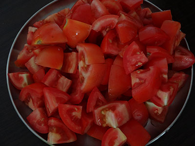 cutting tomato for tomato pickle or tomato uppinakayi