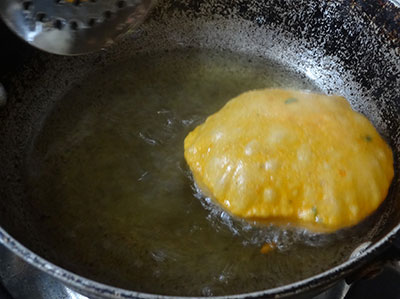 deep frying the rolled tomato poori