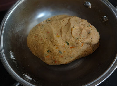 preparing dough for tomato poori