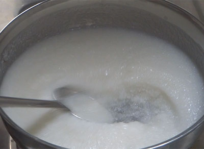 stirring the batter for akki kadubu and simple saru recipe