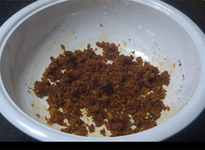 mixing coconut, jaggery and rasam powder for avalaki upkari or spicy thin poha snacks