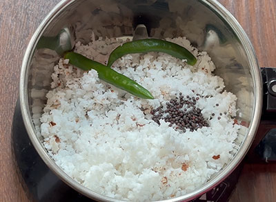 grinding coconut, green chillies and mustard for dappa menasu mosaru sasive or capsicum raita