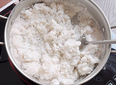 mixing the dough for kayi rotti or coconut roti recipe