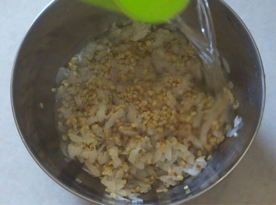 soaking urad dal, methi seeds and poha for jowar dosa or jolada hittina dose
