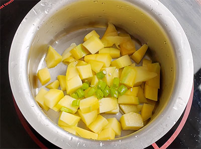 peel and cut raw mango for mavinakayi neer gojju or raw mango recipe