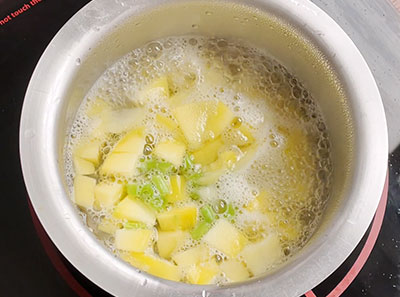 cook mango and green chilli for mavinakayi neer gojju or raw mango recipe