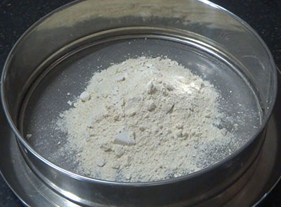 sieving urad flour for uddina happala or urad dal papad