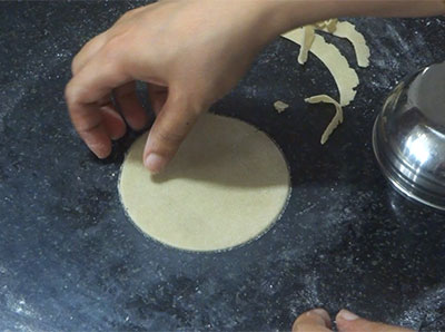rolling the dough for uddina happala or urad dal papad